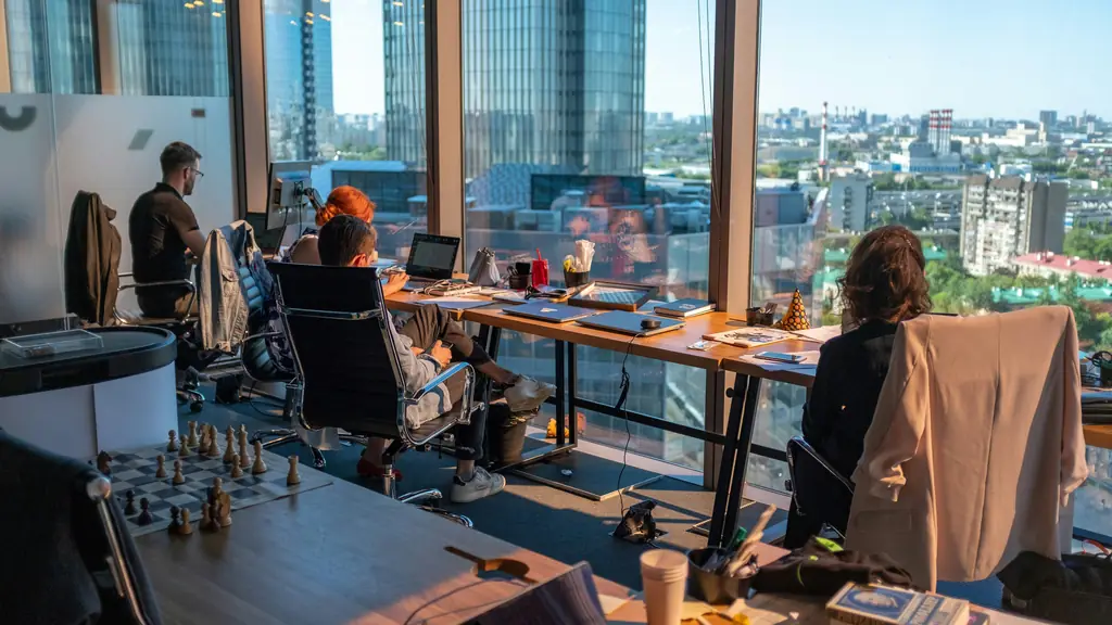 A team working at their desks by the windows of an office above the city
